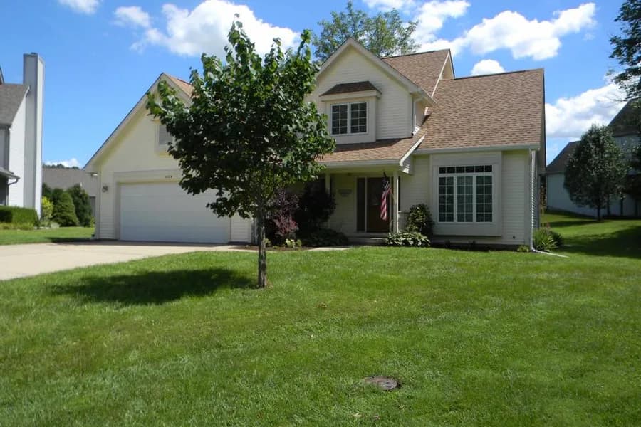 A two-story home with a covered porch, listed by The HOME TEAM Properties.
